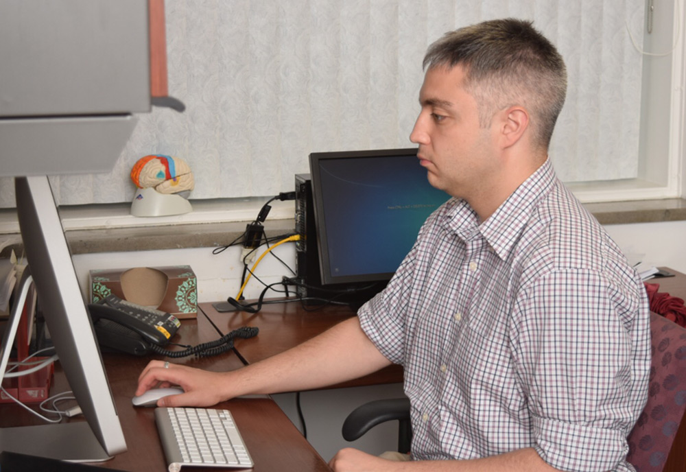 Researcher at computer, concentrating